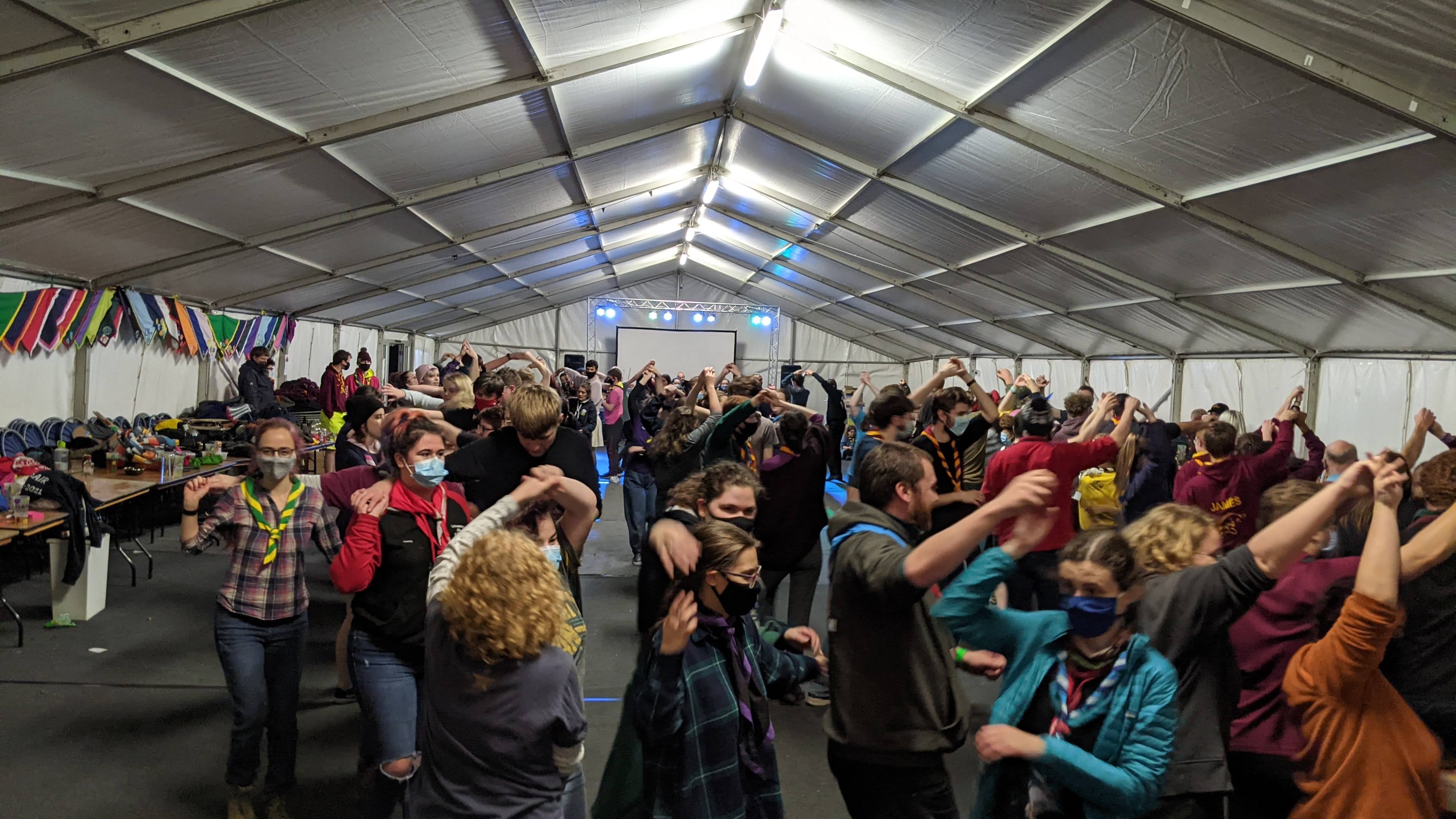Wide shot of the marquee with people dancing during the ceilidh