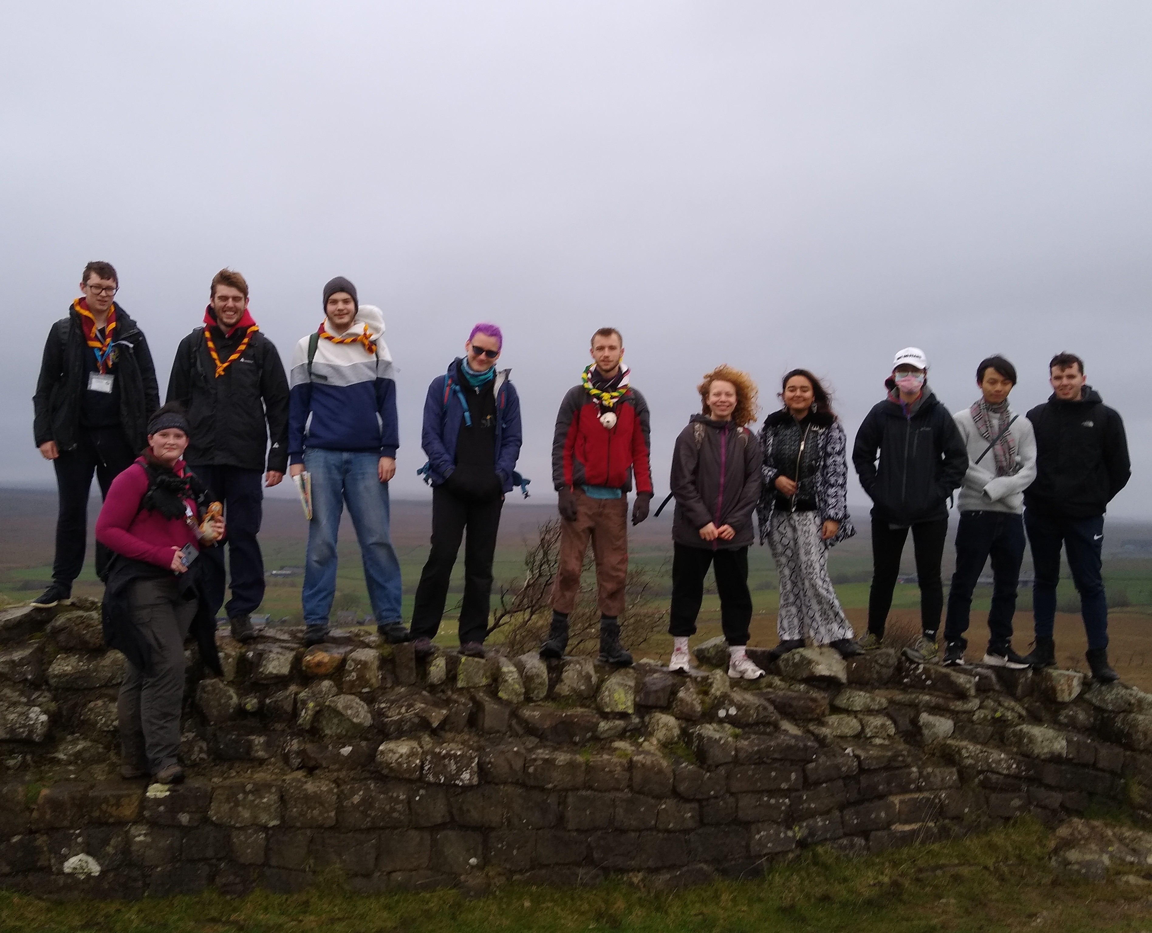 Group photo of those on the Easy Hike activity, standing atop Hadrian's Wall